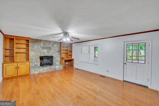 208 Earlwood Dr, Dublin, GA 31021 - unfurnished living room featuring baseboards, visible vents, wood finished floors, and a textured ceiling
