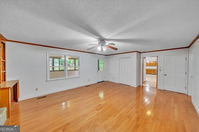 208 Earlwood Dr, Dublin, GA 31021 - interior space featuring crown molding, a textured ceiling, baseboards, and light wood-type flooring