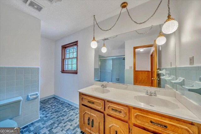 208 Earlwood Dr, Dublin, GA 31021 - full bath featuring double vanity, toilet, a shower stall, and a sink