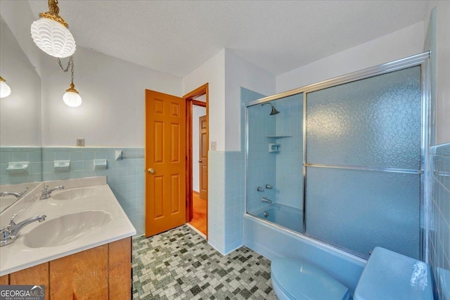 208 Earlwood Dr, Dublin, GA 31021 - bathroom with tile walls, enclosed tub / shower combo, toilet, and a sink