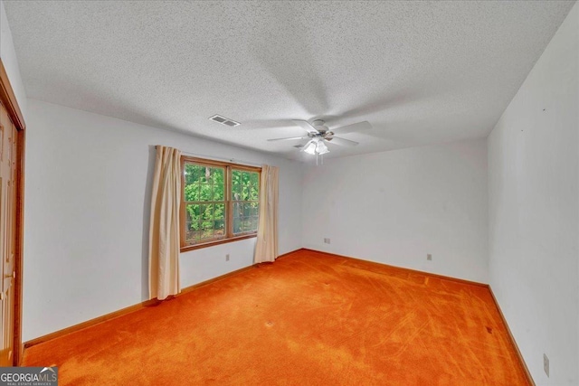 unfurnished room featuring a textured ceiling, carpet flooring, visible vents, baseboards, and a ceiling fan