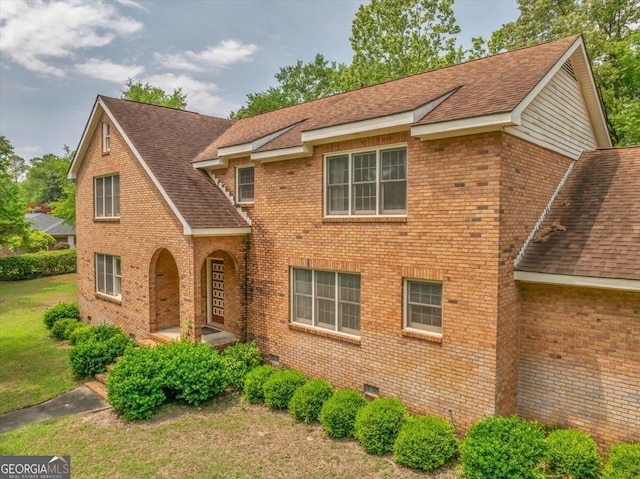 208 Earlwood Dr, Dublin, GA 31021 - view of front of house featuring brick siding, a front lawn, and roof with shingles