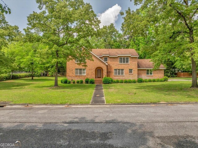 208 Earlwood Dr, Dublin, GA 31021 - traditional home featuring a front lawn and brick siding