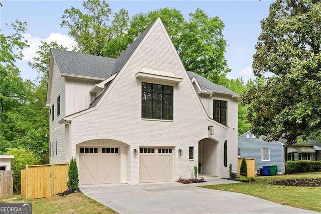 3006 Skyland Dr NE, Brookhaven, GA 30341 - french country inspired facade with fence, roof with shingles, driveway, and an attached garage