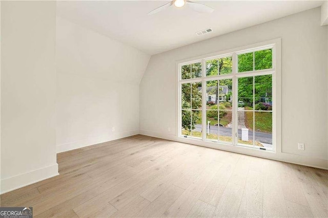 3006 Skyland Dr NE, Brookhaven, GA 30341 - spare room featuring baseboards, visible vents, light wood-style floors, and vaulted ceiling