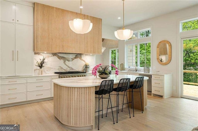 3006 Skyland Dr NE, Brookhaven, GA 30341 - kitchen with decorative backsplash, light wood-style flooring, a kitchen island, and a sink