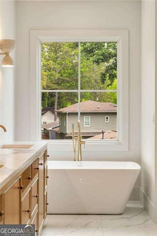 3006 Skyland Dr NE, Brookhaven, GA 30341 - full bathroom featuring a freestanding tub, vanity, and marble finish floor