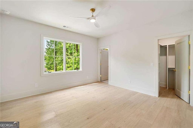 3006 Skyland Dr NE, Brookhaven, GA 30341 - unfurnished bedroom with a spacious closet, light wood-type flooring, visible vents, and baseboards