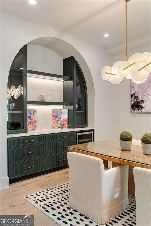 3006 Skyland Dr NE, Brookhaven, GA 30341 - dining room featuring recessed lighting, arched walkways, and light wood-style flooring