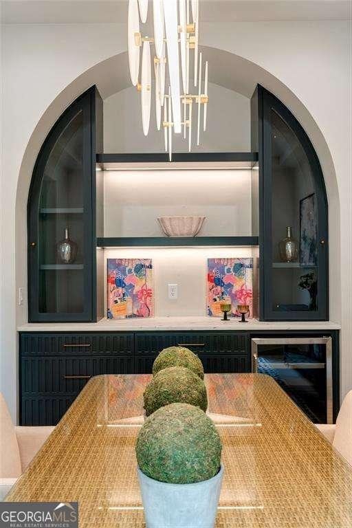 3006 Skyland Dr NE, Brookhaven, GA 30341 - bar featuring a notable chandelier and wine cooler