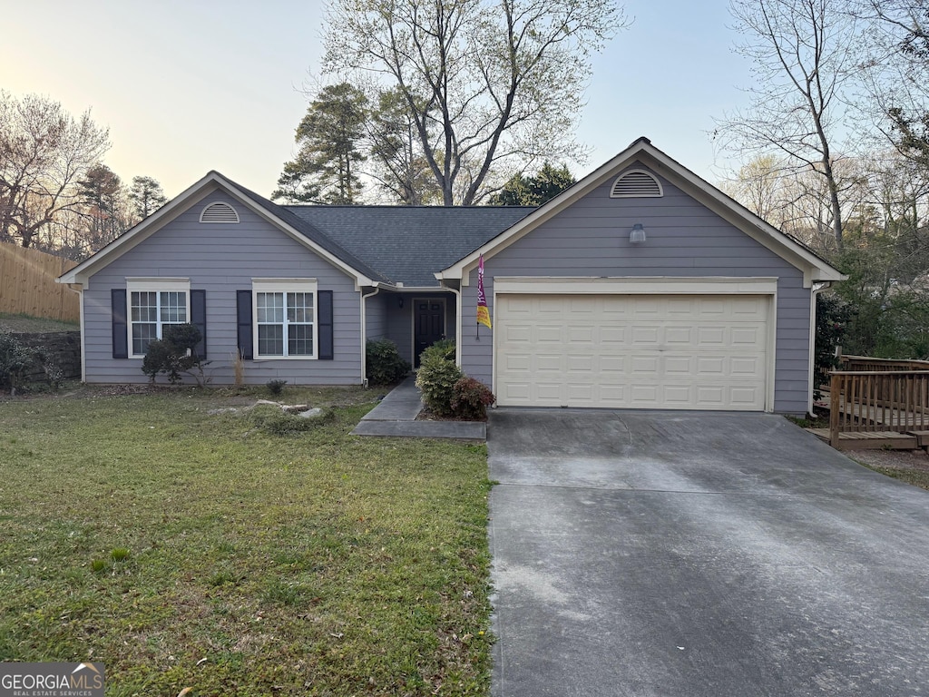 959 Romer Pl, Stone Mountain, GA 30083 - ranch-style house with driveway, an attached garage, and a lawn