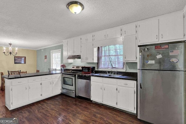 4850 Forest Blvd, Gainesville, GA 30506 - kitchen featuring a textured ceiling, appliances with stainless steel finishes, under cabinet range hood, ornamental molding, and a peninsula