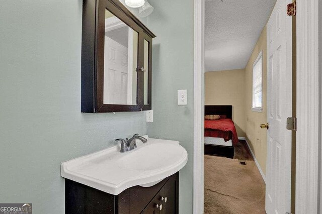 4850 Forest Blvd, Gainesville, GA 30506 - bathroom with a textured ceiling, vanity, and baseboards