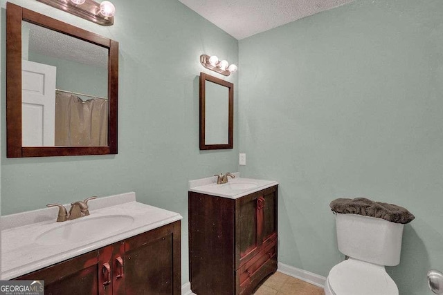 4850 Forest Blvd, Gainesville, GA 30506 - bathroom with baseboards, two vanities, tile patterned flooring, and a sink