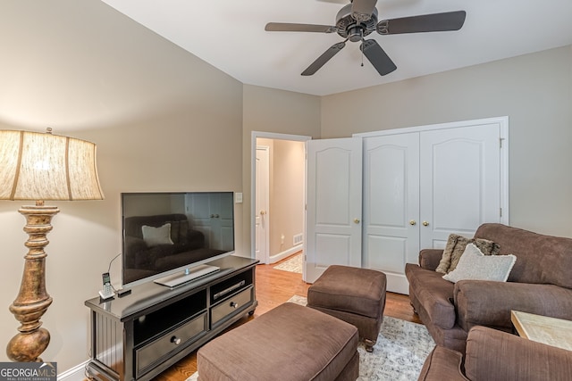 living area with ceiling fan, wood finished floors, and visible vents