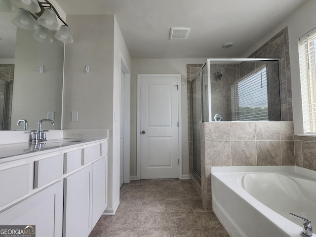 full bathroom with a garden tub, a stall shower, visible vents, and a healthy amount of sunlight
