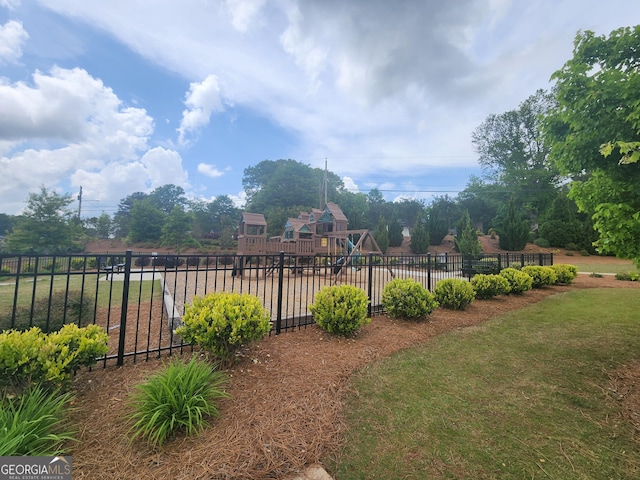 view of yard with fence and a playground