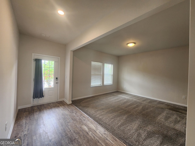 entrance foyer featuring wood finished floors and baseboards