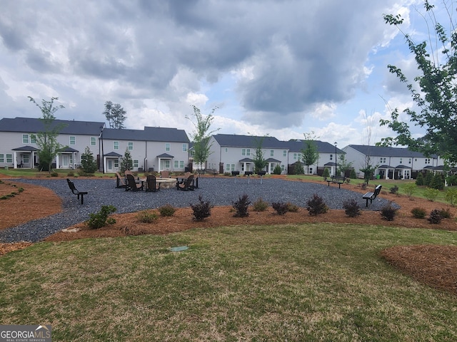 view of home's community featuring a residential view and a yard
