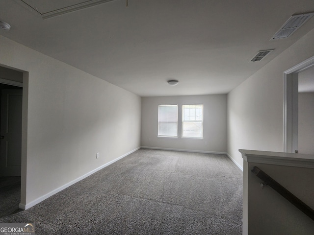 unfurnished room with visible vents, baseboards, and carpet floors