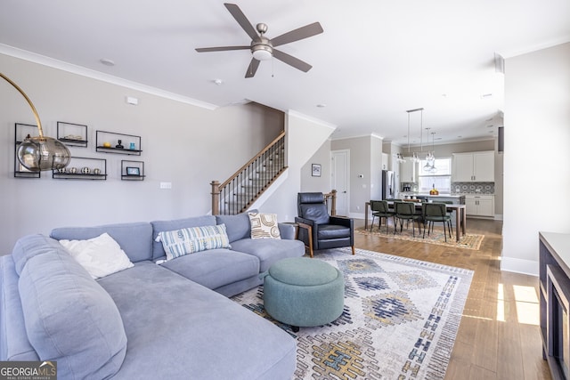 834 S Columbia Dr, Decatur, GA 30030 - living room with light wood-style flooring, ceiling fan, stairway, crown molding, and baseboards