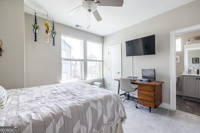bedroom with carpet floors, multiple windows, ensuite bath, and visible vents