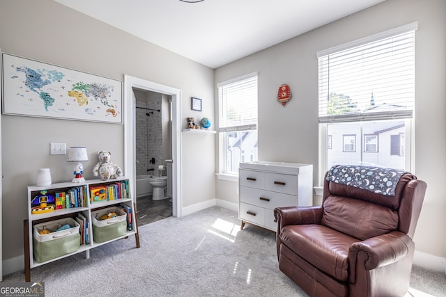 sitting room featuring baseboards and carpet