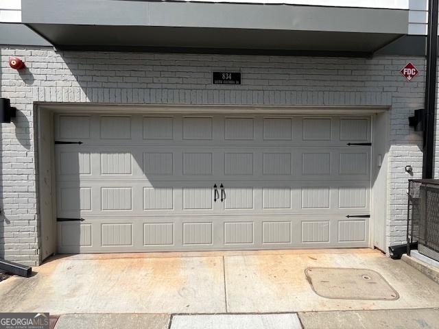 garage featuring concrete driveway