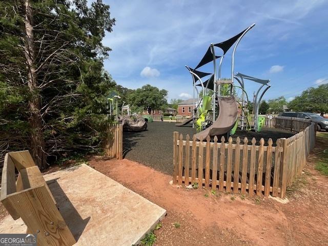 view of playground featuring fence