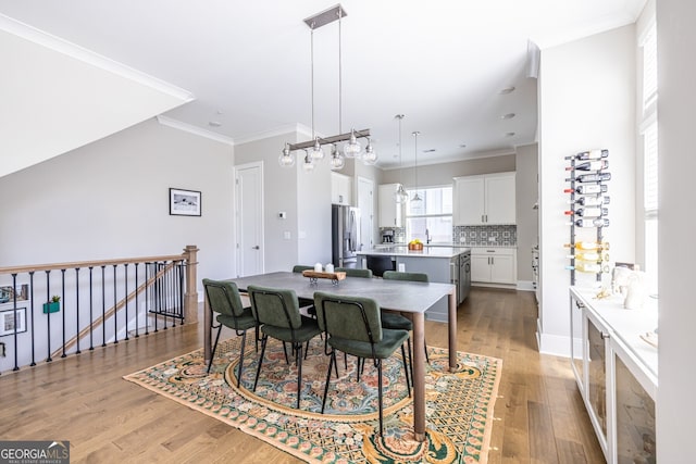 834 S Columbia Dr, Decatur, GA 30030 - dining space with light wood-style floors, ornamental molding, and baseboards