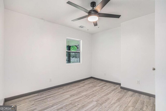 1477 Olive St SW, Atlanta, GA 30310 - spare room with wood finished floors, a ceiling fan, and baseboards