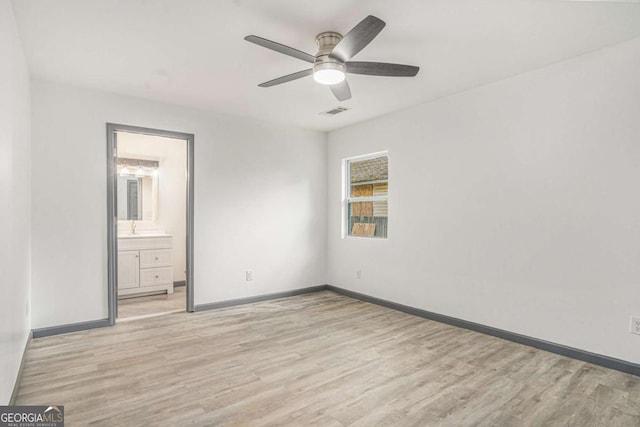 1477 Olive St SW, Atlanta, GA 30310 - unfurnished bedroom with light wood-type flooring, baseboards, a sink, and ceiling fan
