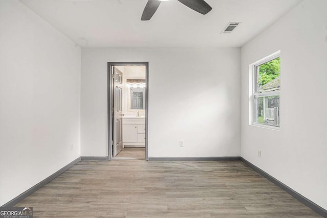 1477 Olive St SW, Atlanta, GA 30310 - spare room with a ceiling fan, light wood-style floors, and baseboards
