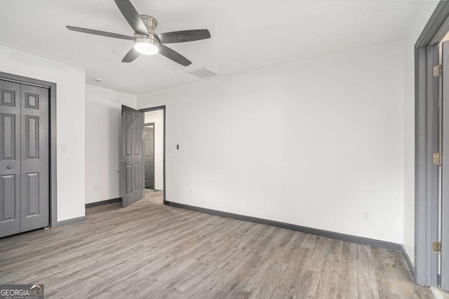 1477 Olive St SW, Atlanta, GA 30310 - unfurnished bedroom with light wood-style floors, baseboards, a ceiling fan, and a closet