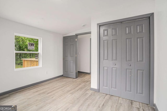 1477 Olive St SW, Atlanta, GA 30310 - unfurnished bedroom featuring light wood finished floors, a closet, baseboards, and vaulted ceiling