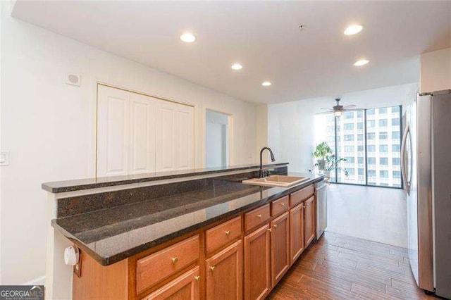 3040 Peachtree Rd NW Unit 815, Atlanta, GA 30305 - kitchen with a sink, appliances with stainless steel finishes, recessed lighting, dark wood-type flooring, and brown cabinets