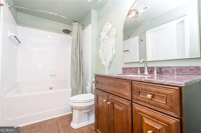 3040 Peachtree Rd NW Unit 815, Atlanta, GA 30305 - bathroom featuring wood finished floors, toilet, shower / tub combo with curtain, and vanity