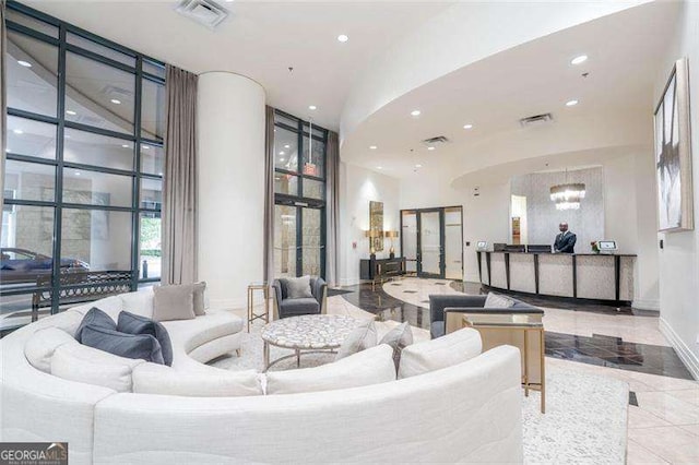 3040 Peachtree Rd NW Unit 815, Atlanta, GA 30305 - building lobby with a towering ceiling, a wall of windows, and recessed lighting