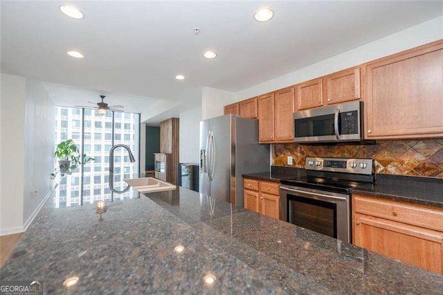 3040 Peachtree Rd NW Unit 815, Atlanta, GA 30305 - kitchen featuring stainless steel appliances, decorative backsplash, ceiling fan, recessed lighting, and baseboards