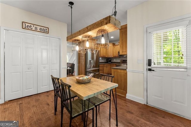 dining room featuring baseboards and dark wood finished floors