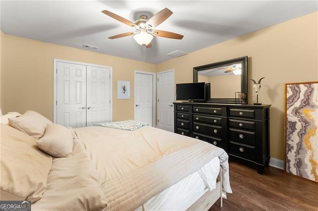 bedroom with dark wood-type flooring, visible vents, a ceiling fan, and baseboards