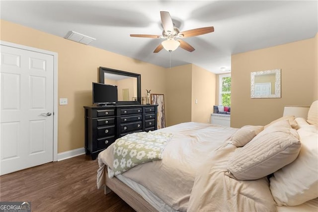 bedroom with a ceiling fan, visible vents, baseboards, and dark wood-type flooring