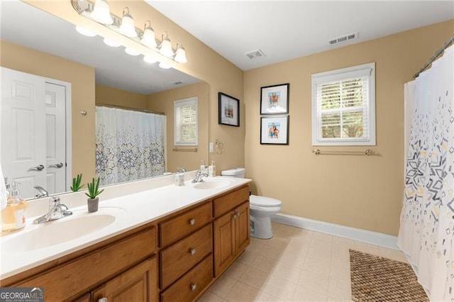 bathroom with toilet, a sink, baseboards, and visible vents