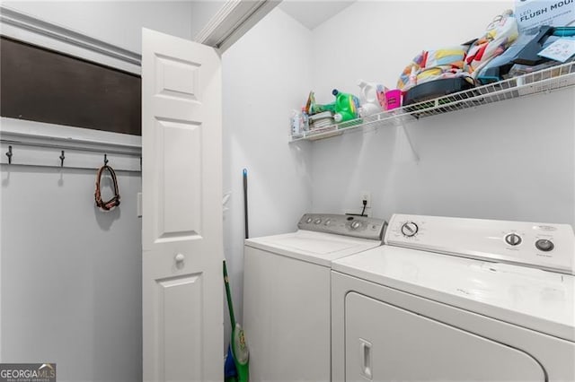 clothes washing area featuring washing machine and clothes dryer and laundry area