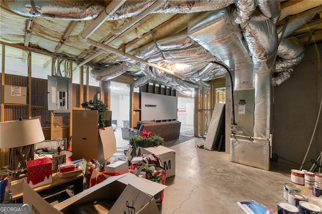 basement featuring heating unit and electric panel