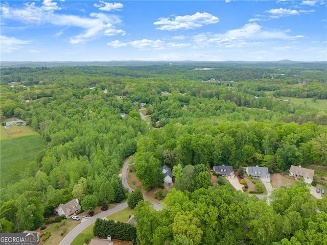 birds eye view of property with a wooded view