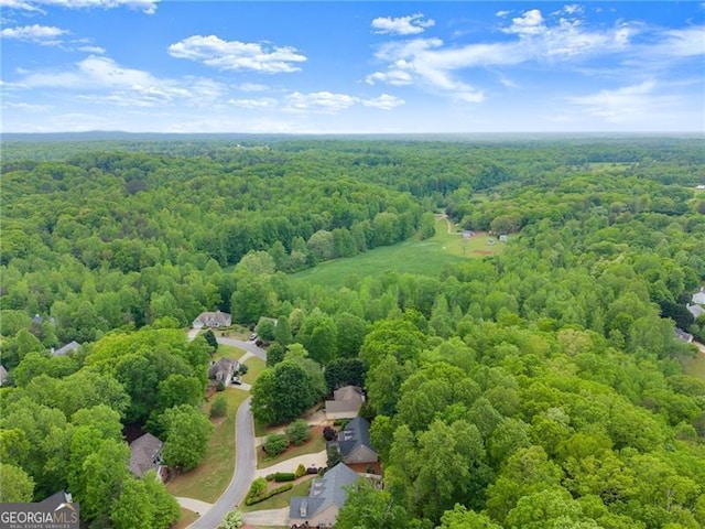 birds eye view of property featuring a wooded view