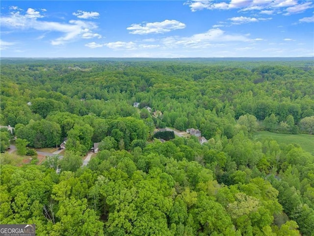 birds eye view of property featuring a view of trees