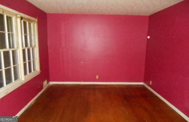 3296 Columbia Woods Dr, Decatur, GA 30032 - empty room featuring wood finished floors and baseboards