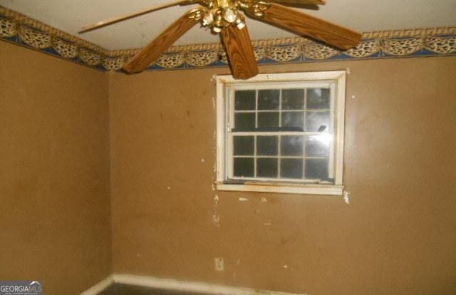 3296 Columbia Woods Dr, Decatur, GA 30032 - spare room featuring ceiling fan and baseboards